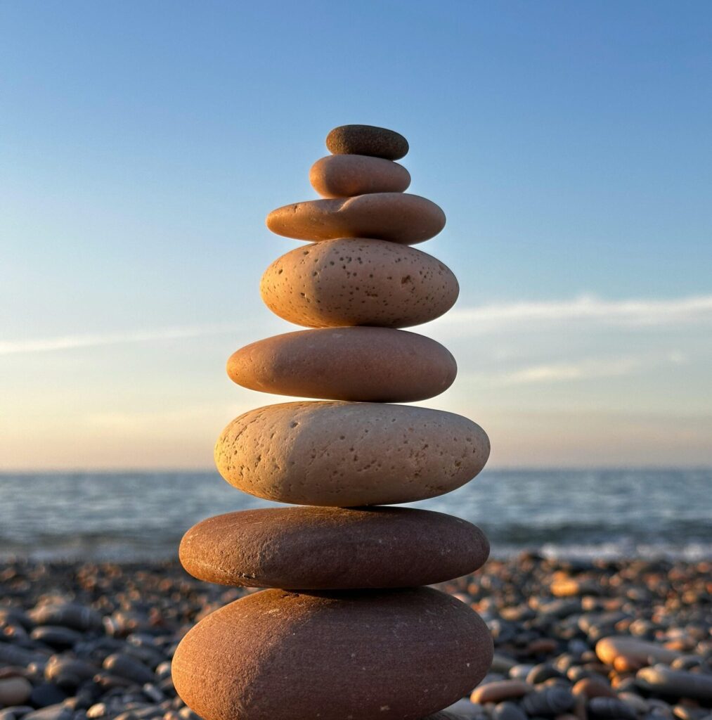 Serene stone stack near the sea at sunset in Cide, Türkiye. Perfect balance and tranquility.